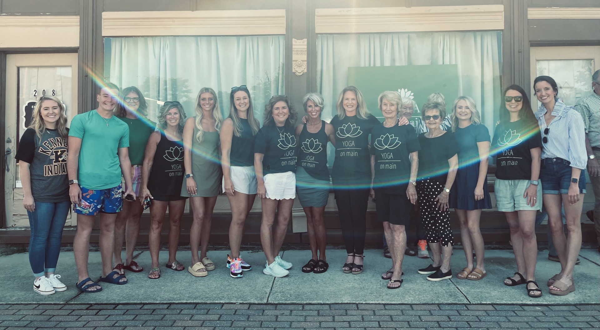 Members and teachers of Yoga on Main gathered together in front of the studio